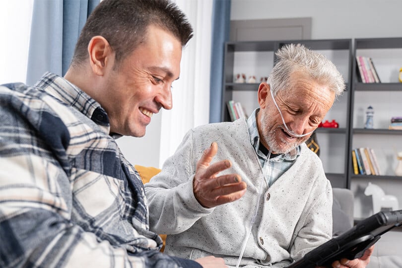 Volunteer | ACVVS | Two men smiling in in Aged Care facility Volunteer | ACVVS | Two men smiling in in Aged Care facility